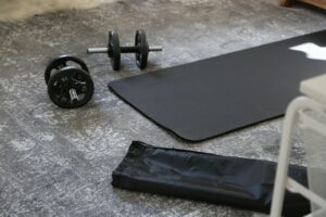 Person performing bodyweight squats and push-ups in a bright living room with an open exercise area.