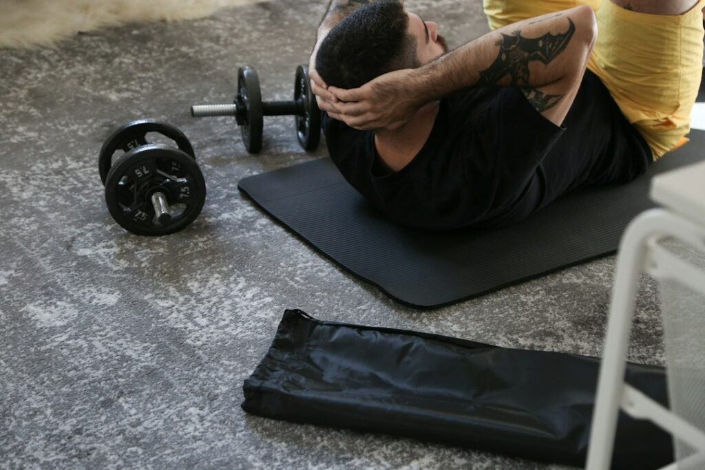Person performing a short bodyweight workout in a bright home space with a chair and exercise mat.